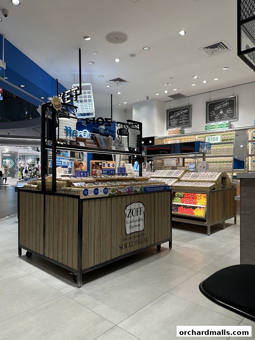 Interior view of a Zoff eyewear store showcasing various glasses and promotional displays.
