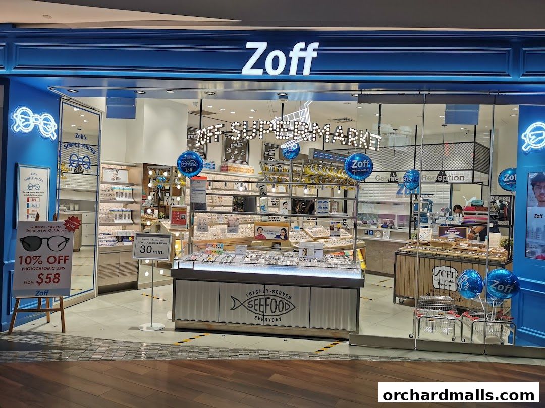 The Zoff store features a bright blue facade with a wide selection of eyeglasses and sunglasses displayed inside.